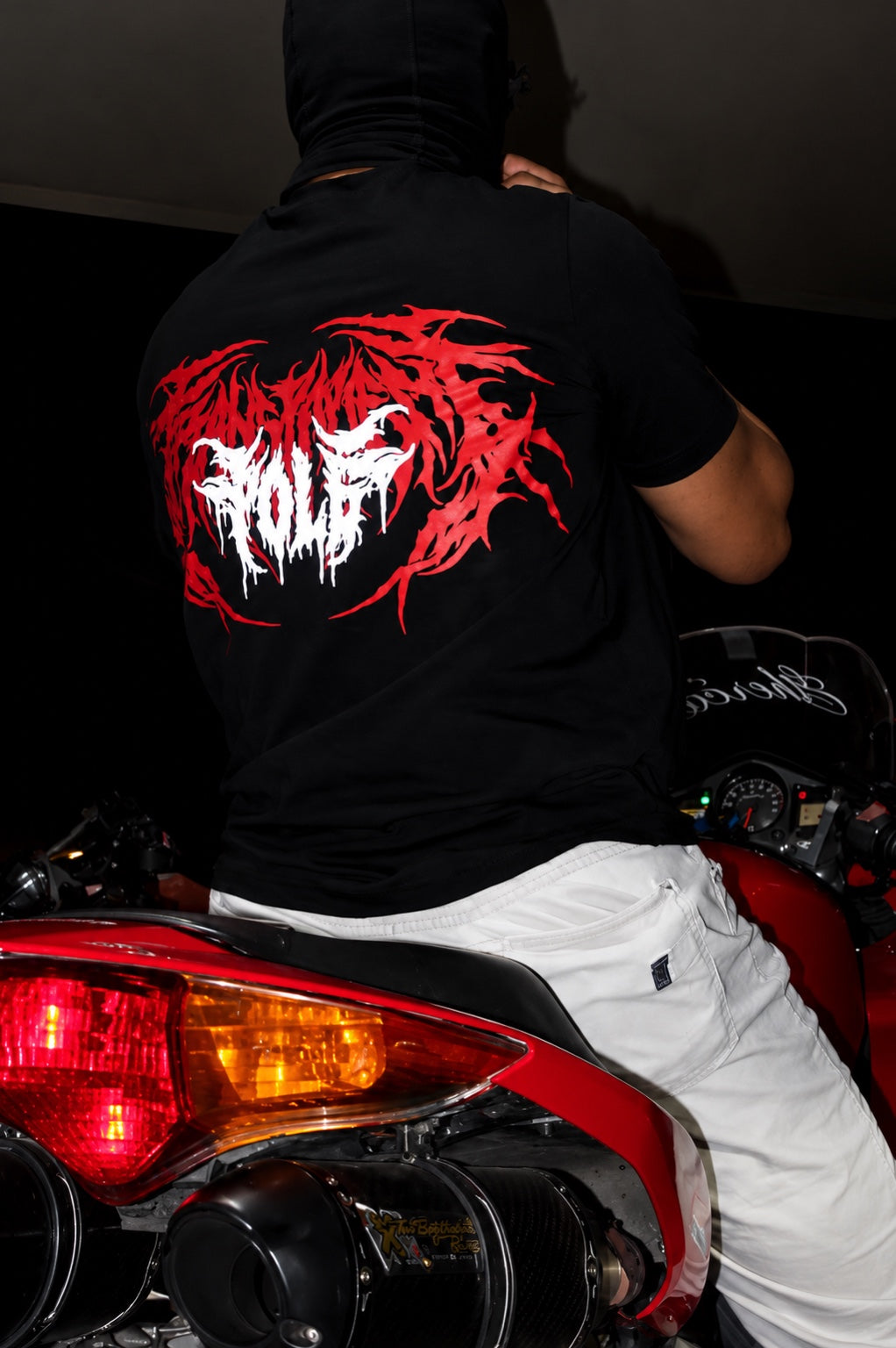 Close-up of POLE graphic shirt on a red motorcycle